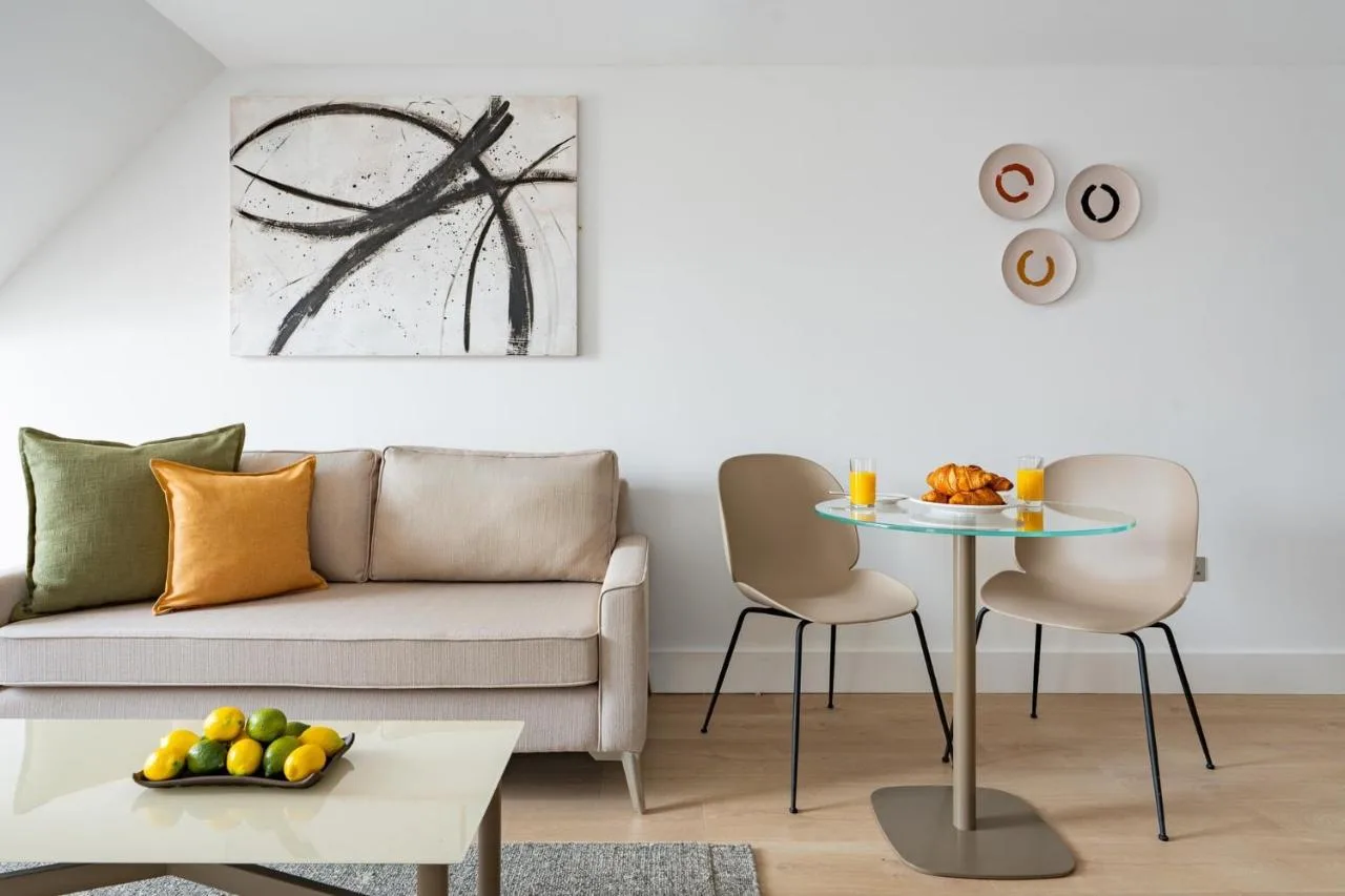 a living room with a couch and a table and chairs at Micklegate by Supercity Aparthotels in York