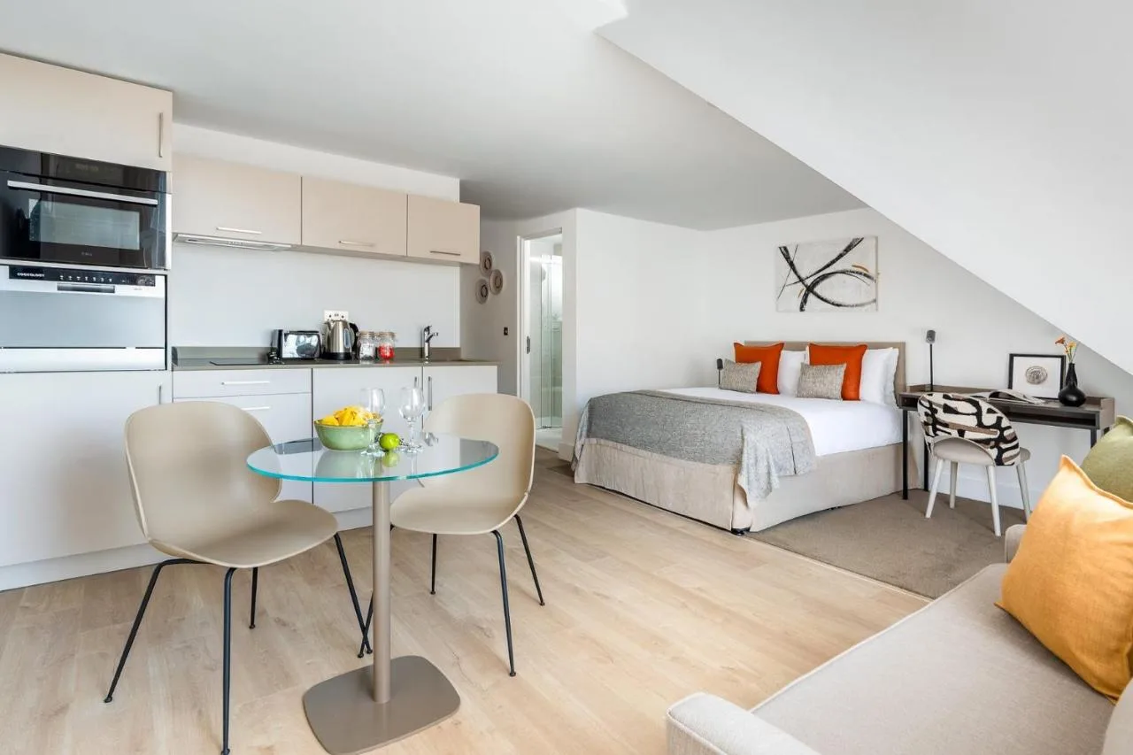 a bedroom with a bed and a table and chairs at Micklegate by Supercity Aparthotels in York