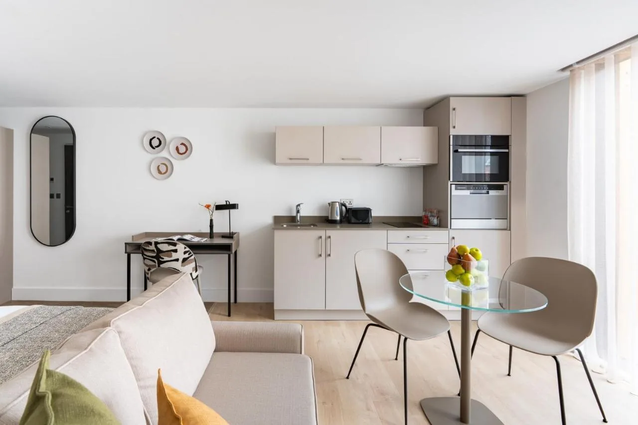 a kitchen and living room with a table and chairs at Micklegate by Supercity Aparthotels in York